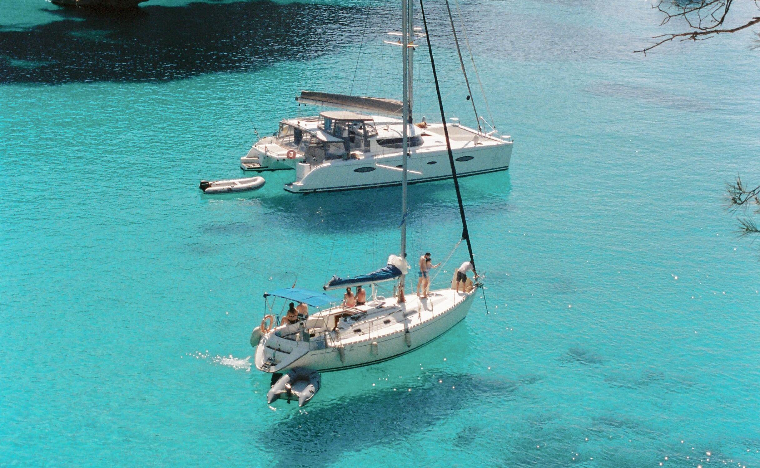 A Monohull and Catamaran in blue waters